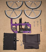 Figure 2.  This picture shows the components of the wheelchair when disassembled.  The 20” circular wheel is disassembled into two semi-circular parts.